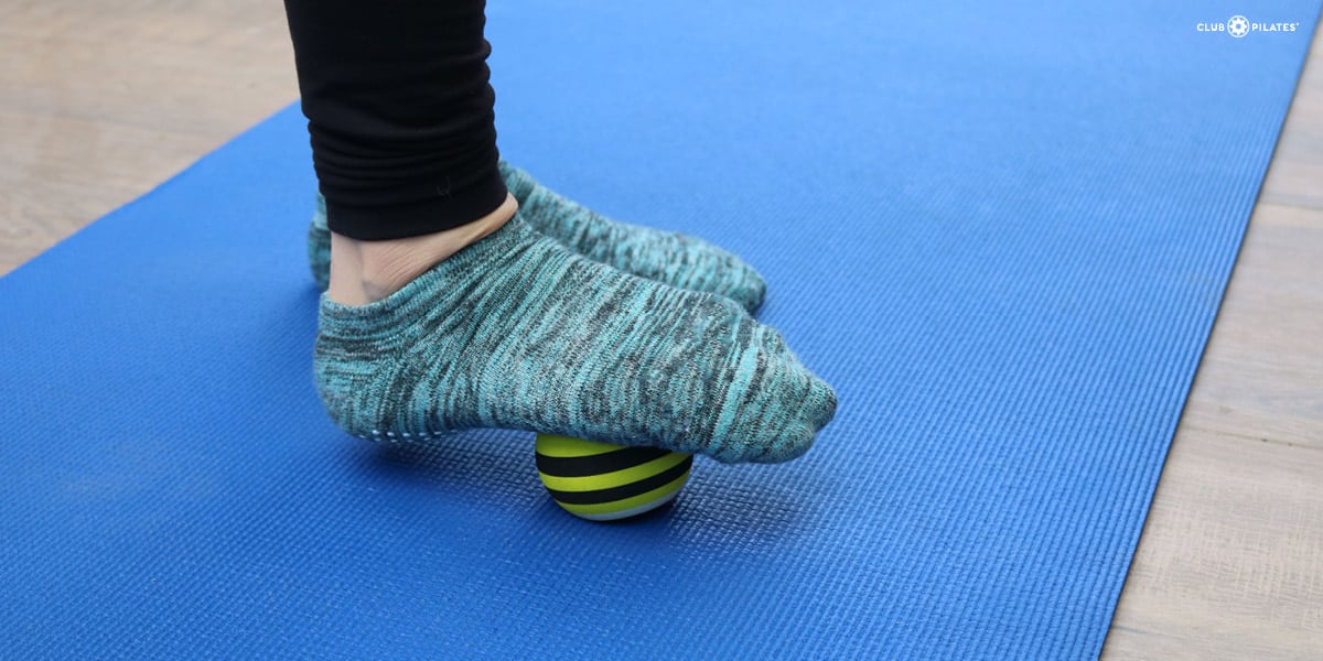 Foot rolling on tennis ball