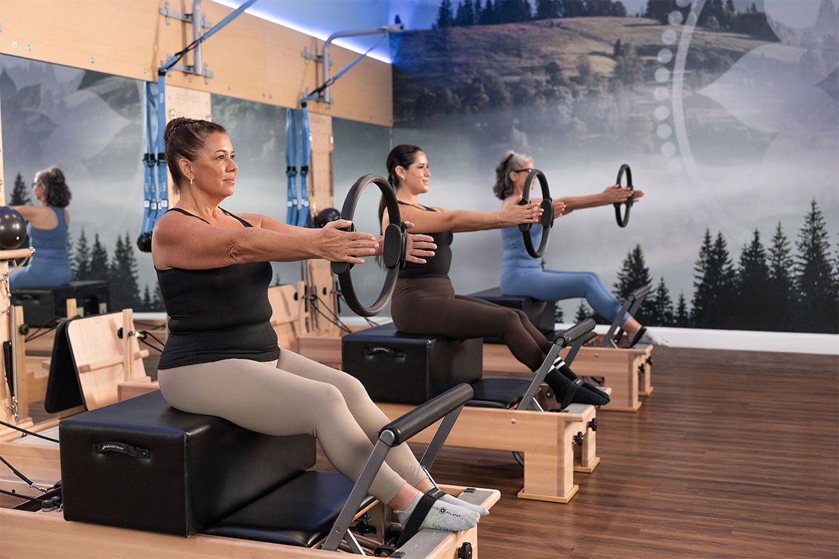 three women in pilates studio