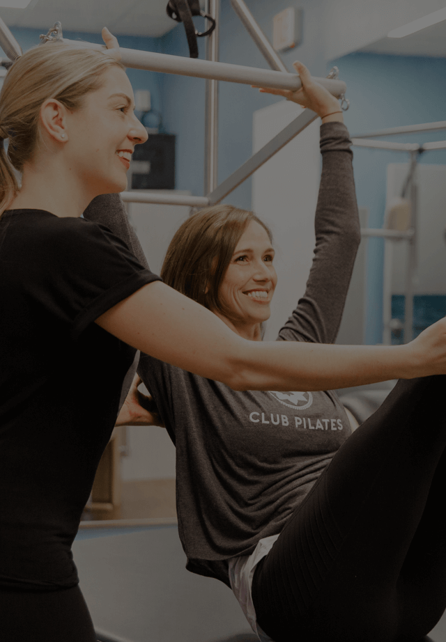 Club Pilates instructor guiding person who is exercising